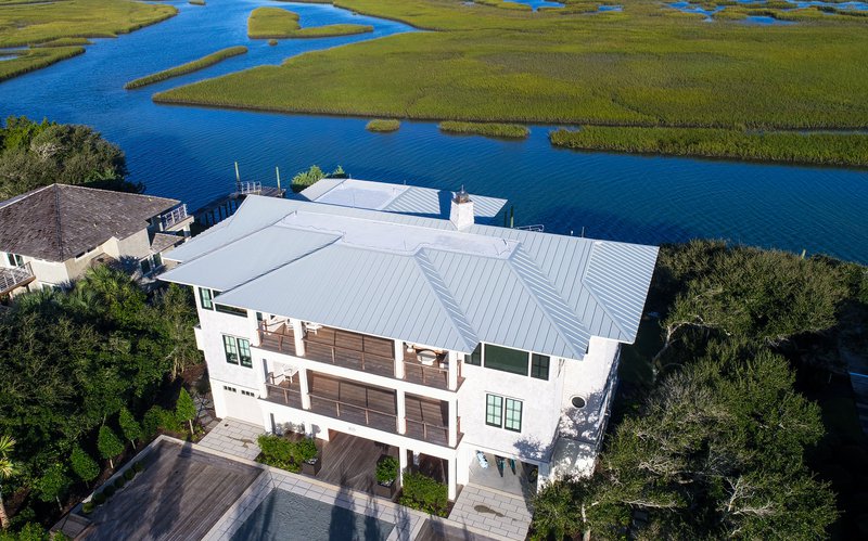 In coastal home construction, drainage planning plays a central role in protecting both the structure and the surrounding land.