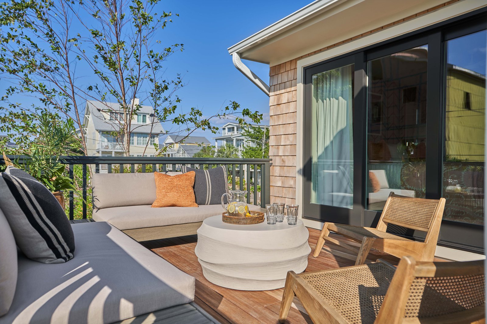 Outdoor lounge with a sofa set and wooden chairs